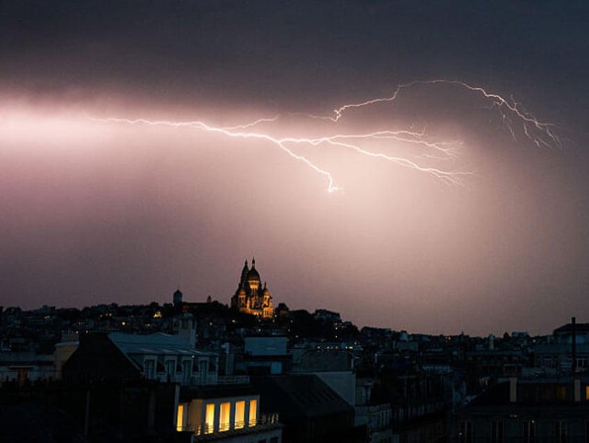 A lighting bolt lights up the sky over Sacre Coeur Basilica in Montmartre during a thunder