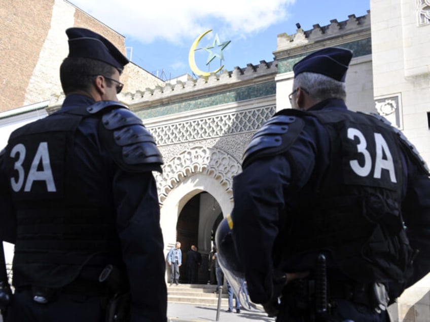 Anti-riot policemen stand in front of the Mosque, on September 22, 2012 in Paris, as polic