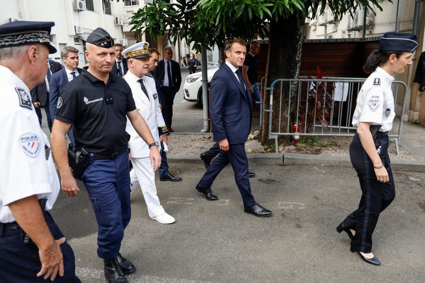 French President Emmanuel Macron (C) visits the central police station in Noumea, France's Pacific territory of New Caledonia on May 23, 2024. France's president made a long-haul trip to the restive Pacific territory of New Caledonia on on May 23, urging a "return to peace" after deadly rioting, and vowing thousands of military reinforcements will be deployed for "as long as necessary". (Photo by Ludovic MARIN / POOL / AFP) (Photo by LUDOVIC MARIN/POOL/AFP via Getty Images)