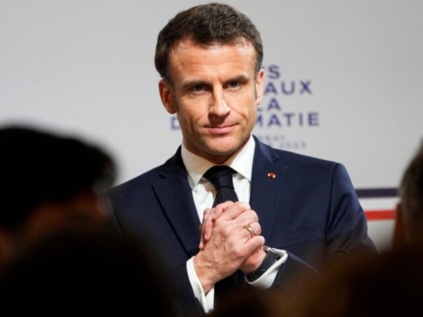 TOPSHOT - French President Emmanuel Macron reacts during the National Roundtable on Diplom