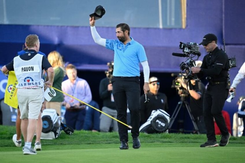 Matthieu Pavon of France waves to the crowd after winning the Farmers Insurance Open at Torrey Pines