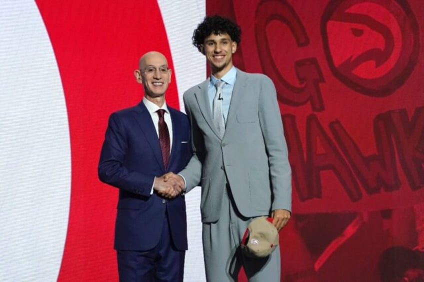 NBA commissioner Adam Silver, left, poses with France's Zaccharie Risacher, right, after R