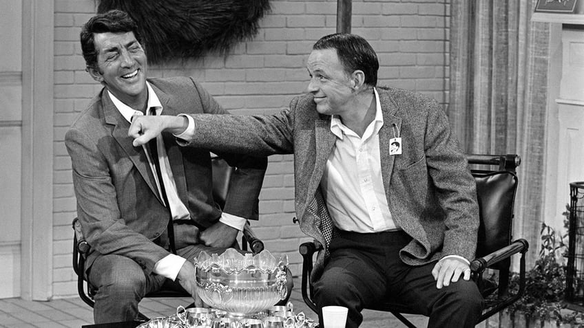 Frank Sinatra playfully punching Dean Martin