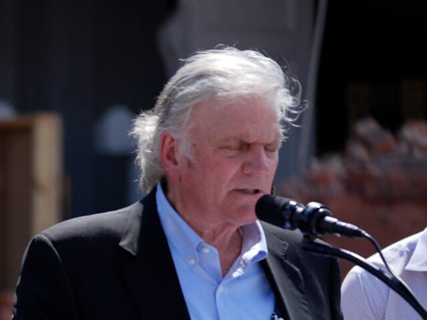 Republican presidential nominee former President Donald Trump listens as Rev. Franklin Gra