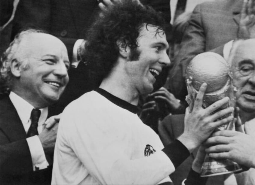 West Germany captain Franz Beckenbauer holds the World Cup trophy after his team's victory over the Netherlands at the Olympic Stadium in Munich on July 7, 1974