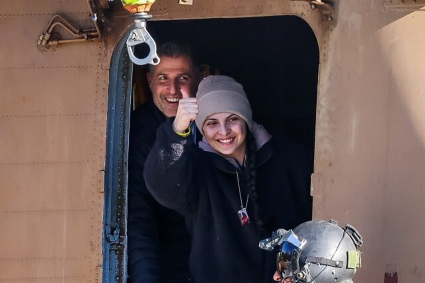 Newly released Israeli hostage Daniella Gilboa gestures as she leaves a military helicopte