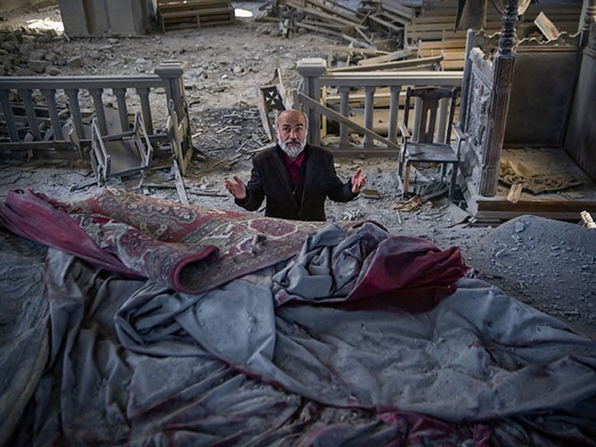 Arthur Sahakyan, 63, prays inside the damaged Ghazanchetsots (Holy Saviour) Cathedral in t