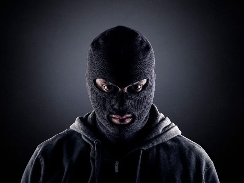 a kidnapper in a black mask
