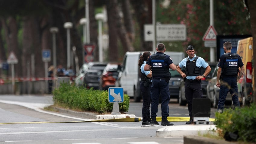 French police stand guard after cars were set on fire in front of the citys synagogue, in La Grande-Motte