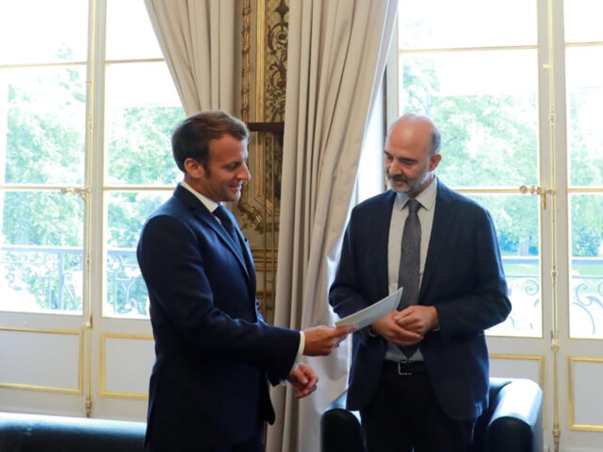 French President Emmanuel Macron (L) receives the annual financial report on the French Presidency Budget of the Court of Auditors (Cour des Comptes) from First President of the Cour des Comptes, Pierre Moscovici (R), at Elysee palace in Paris, on July 28, 2020. (Photo by Christophe PETIT TESSON / POOL …