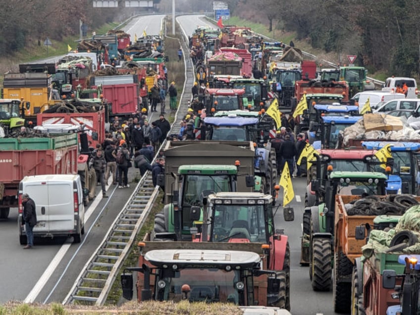 AGEN, FRANCE - JANUARY 22: Farmers with nearly 200 tractors block the A62 freeway to hold a protest against rising taxes, levies, unfair competition and the many difficulties facing the agricultural sector and in Agen, France on January 22, 2024. Farmers were camping out on the freeway this evening in …