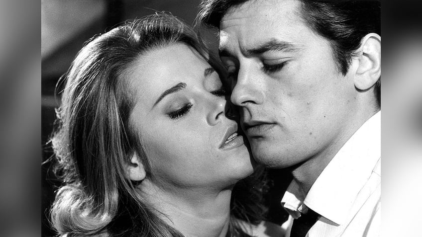 Black and white photo of Jane Fonda with her face pressed against Alain Delon's in "Joy House"