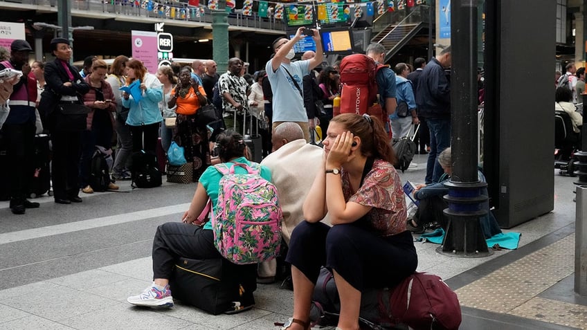 French travelers wait in train station