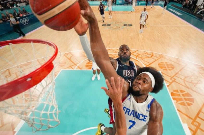 France's Guerschon Yabusele, shown making a basket at the Paris Olympics final, has report