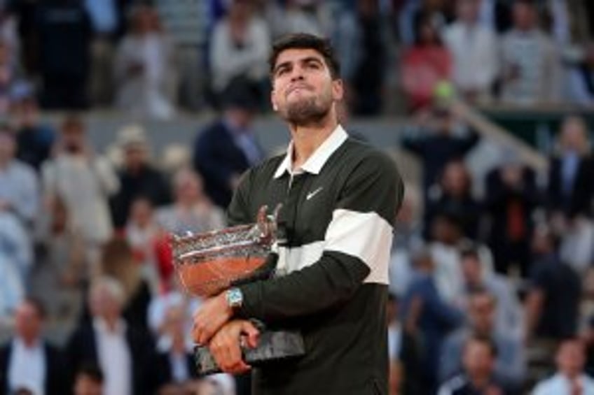 French Open: Alcaraz rallies to defeat Sinner in record-long finale