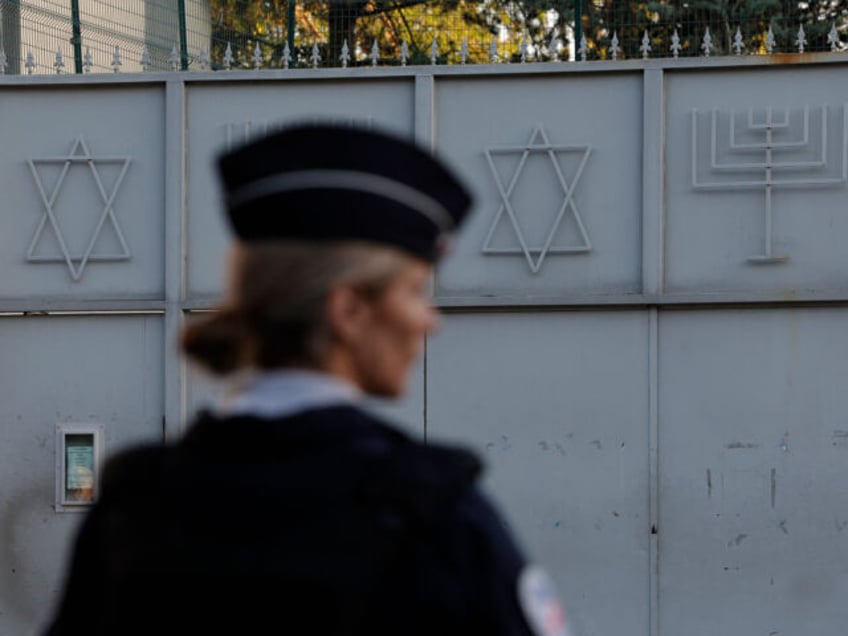 A French police officer stands guard in front of the Synagogue of Sarcelles, Paris's subur
