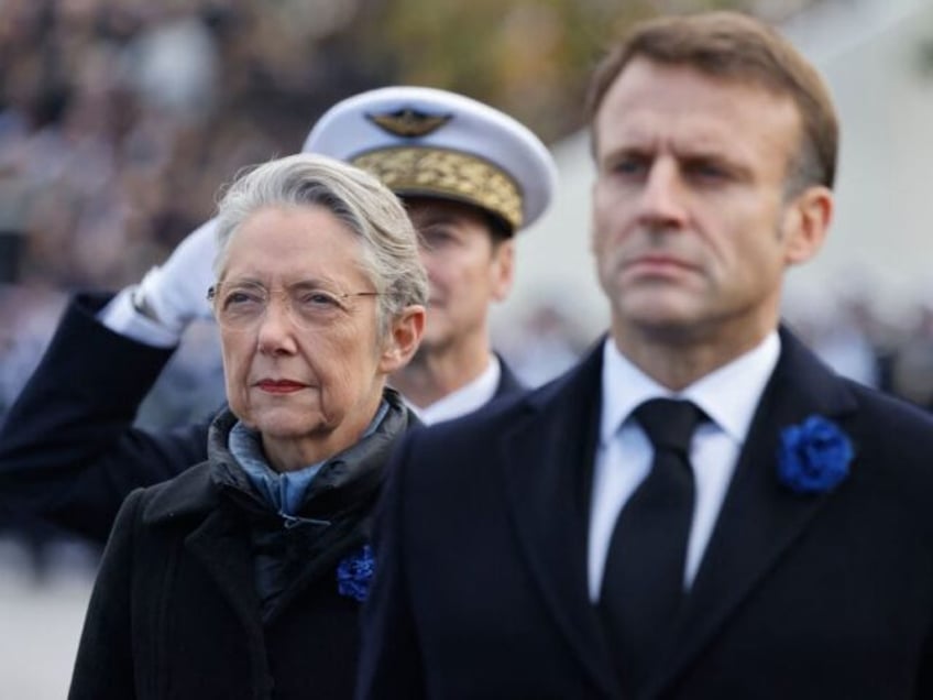 French President Emmanuel Macron, flanked by French Prime Minister Elisabeth Borne, attend a ceremony at the Tomb of the Unknown Soldier at the Arc de Triomphe in Paris on November 11, 2023, as part of commemorations marking the 105th anniversary of the November 11, 1918 Armistice, ending World War I …