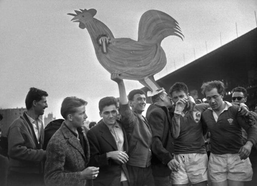 Lucien Mias (second from right) wiping away the tears after his side's 11-3 win over Wales