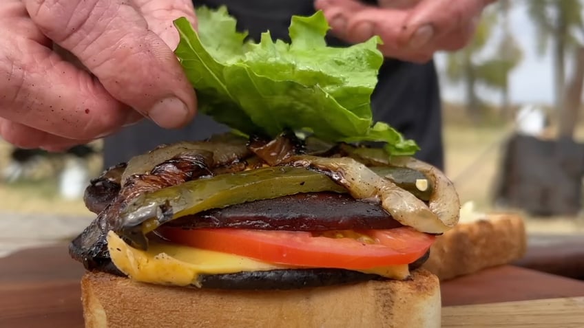 "Cowboy" Kent Rollins puts the finishing touches on his fried bologna sandwich.