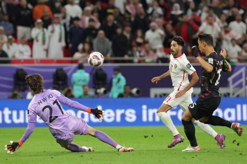 Jordan's forward Yazan Al-Naimat scores the opening goal