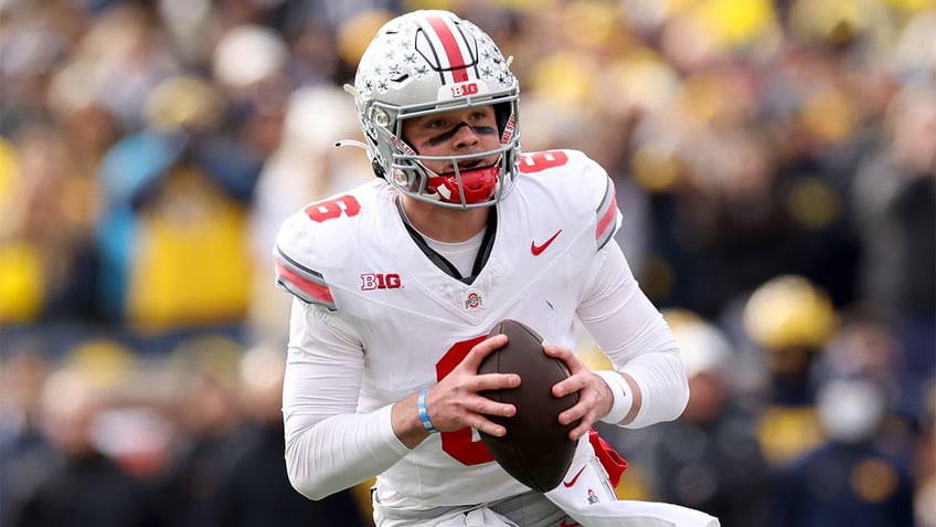 Kyle McCord looks to pass against Michigan