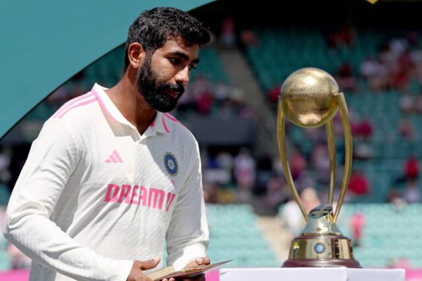 India’s Jasprit Bumrah walkls past the Border-Gavaskar trophy