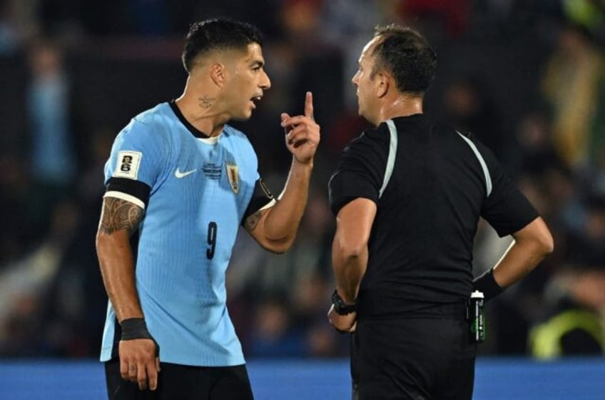 Uruguay forward Luis Suarez argues with Argentine referee Dario Herrera in his final inter