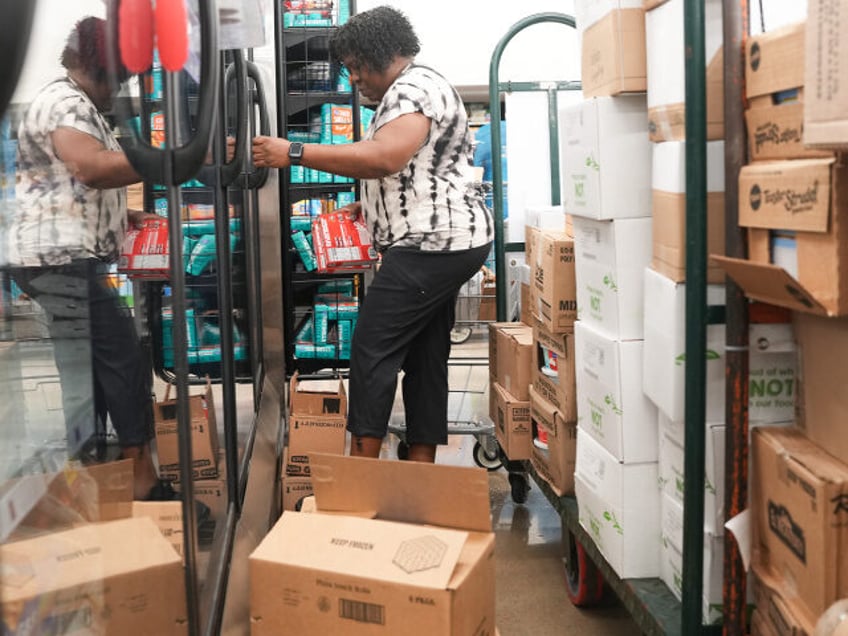 Dalana Turner, a Cincinnati-Dayton based Kroger employee, restocks the freezer section at