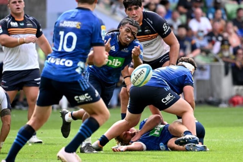 Auckland Blues scrum-half Taufa Funaki (C) scored two of his side's eight tries on Friday