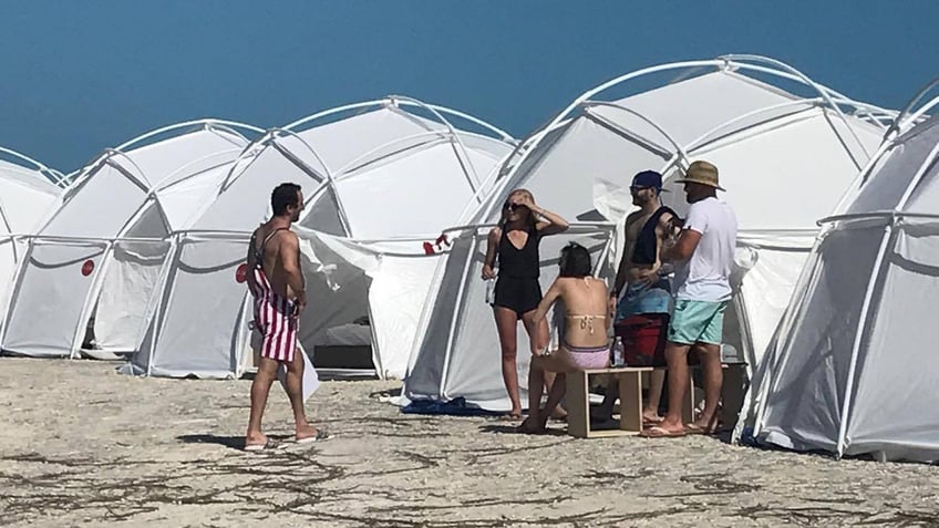 Fyre Festival attendees stand outside of FEMA tents