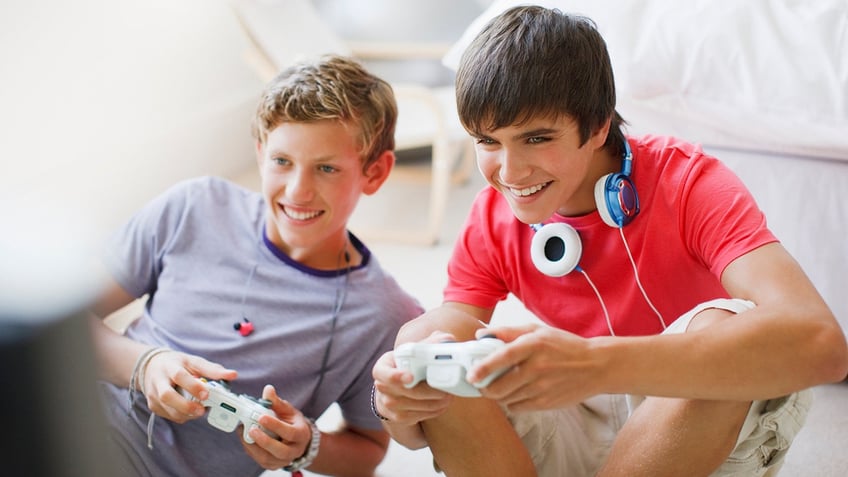 teen boys play video game