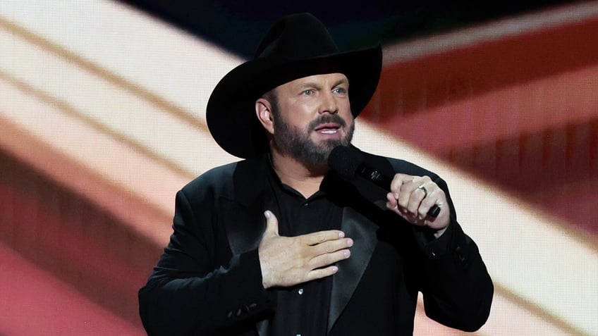 Garth Brooks speaks into a microphone