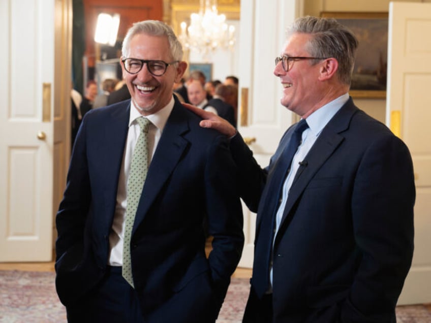 Britain's Prime Minister Keir Starmer, right, laughs with Gary Lineker during a recep