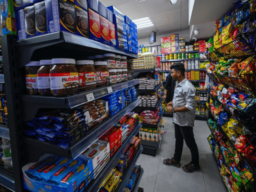SHARJAH, UNITED ARAB EMIRATES- FEBRUARY 22: A the attendant of 24-hour Mini Market in Al T