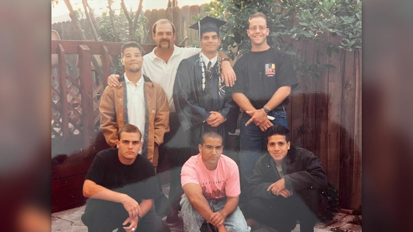 Bruce Bryan and the youths he helped in family photo