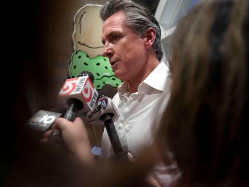 California Gov. Gavin Newsom speaks to reporters Monday, July 8, 2024, in a donut shop, in