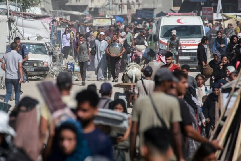 Displaced Palestinians leave an area of Khan Yunis city in Gaza after a new Israeli evacua