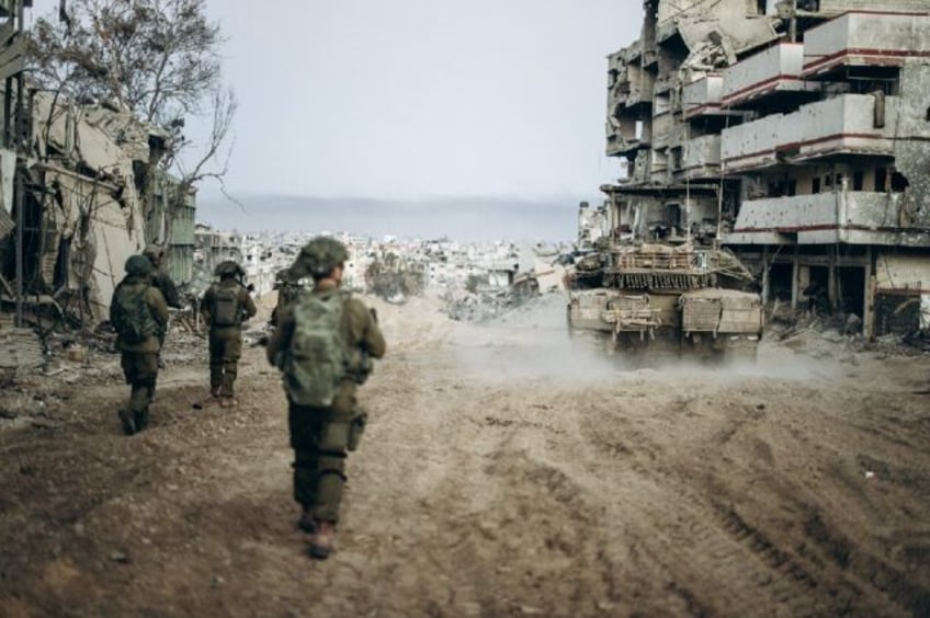 This handout picture released by the Israeli army on January 1, 2024 shows Israeli soldiers operating in the Gaza Strip