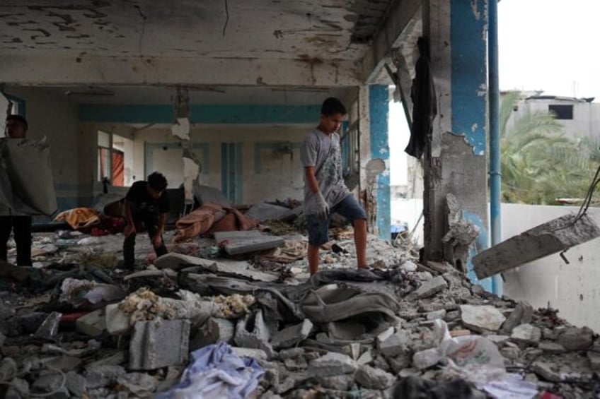 Palestinians at a UN-run school hit during Irsaeli bombradment in central Gaza's Nuseirat