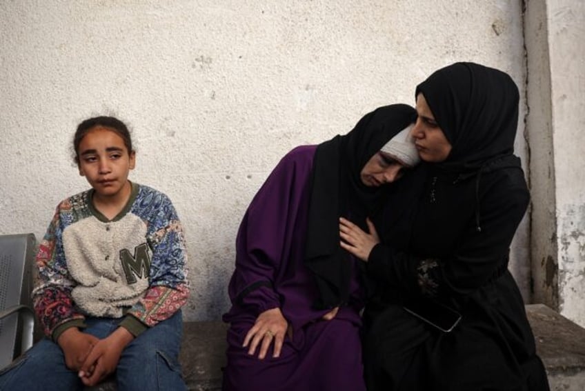 A Palestinian woman mourns her children killed in Israeli bombing in Rafah in the southern
