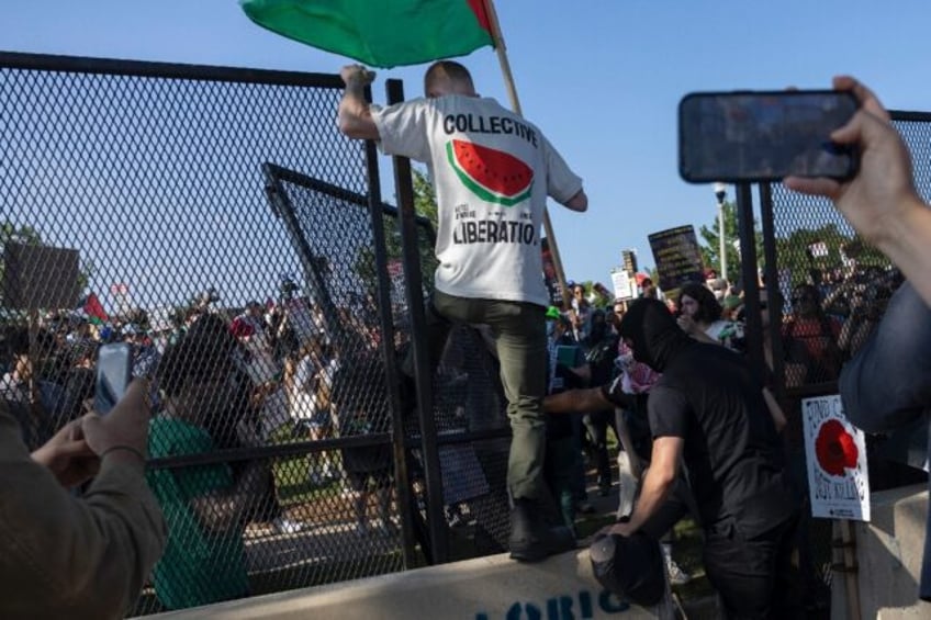 Pro-Palestinian activists breach the security perimeter during a demonstration outside the