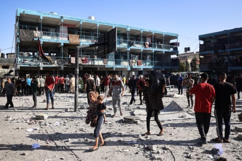 Palestinians in the courtyard of central Gaza's Al-Jawni school after an Israeli air strik