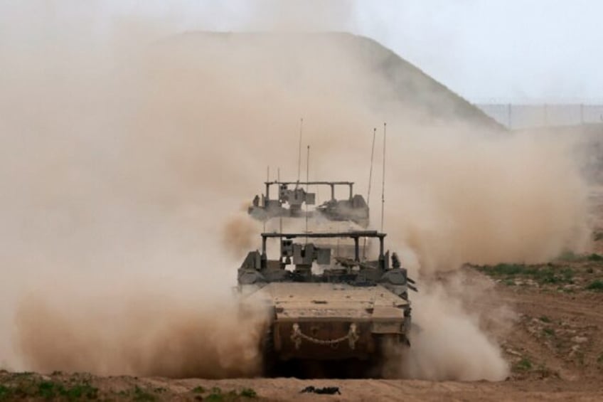 Israeli army vehicles, seen from Israel leaving the Gaza Strip