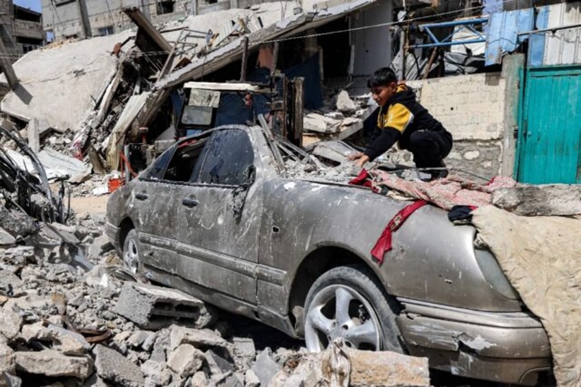 Six months of bloodshed have left much of the Gaza Strip in ruins -- a boy clears rubble i