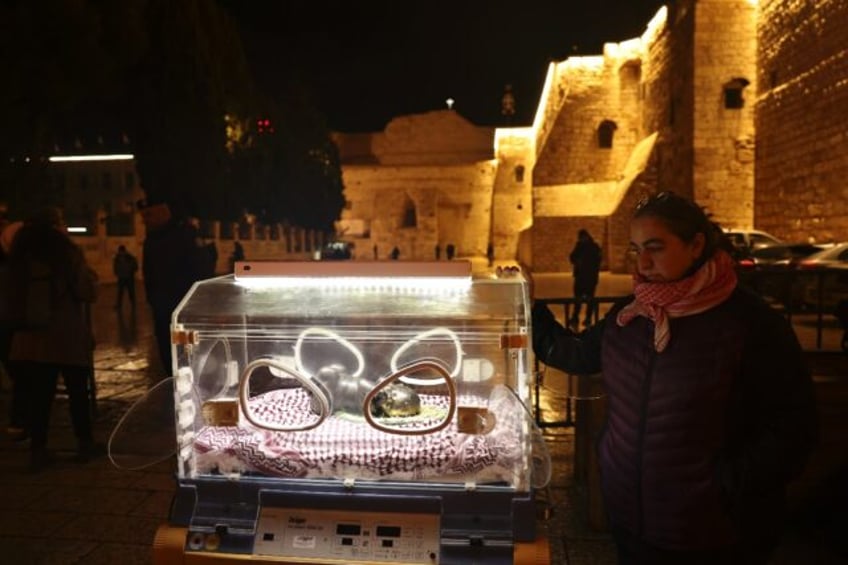 An art installation in front of the Church of the Nativity in Bethlehem depicts the baby Jesus in an incubator