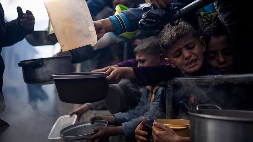 Palestinians line up for food