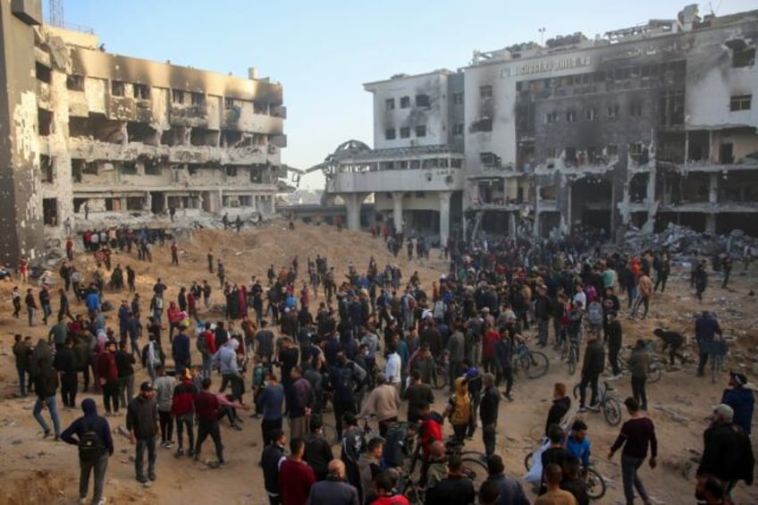 Palestinians inspect the damage at Gaza's Al-Shifa hospital after the Israeli military wit