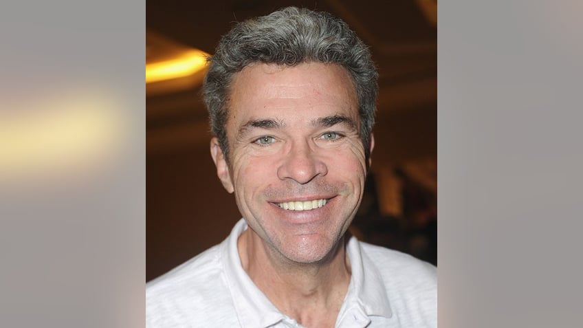 John J. York in a white collared shirt poses for a photo