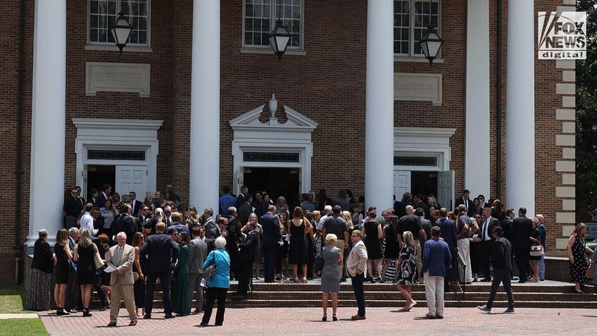 People attend a funeral a church for Johnny Wactor