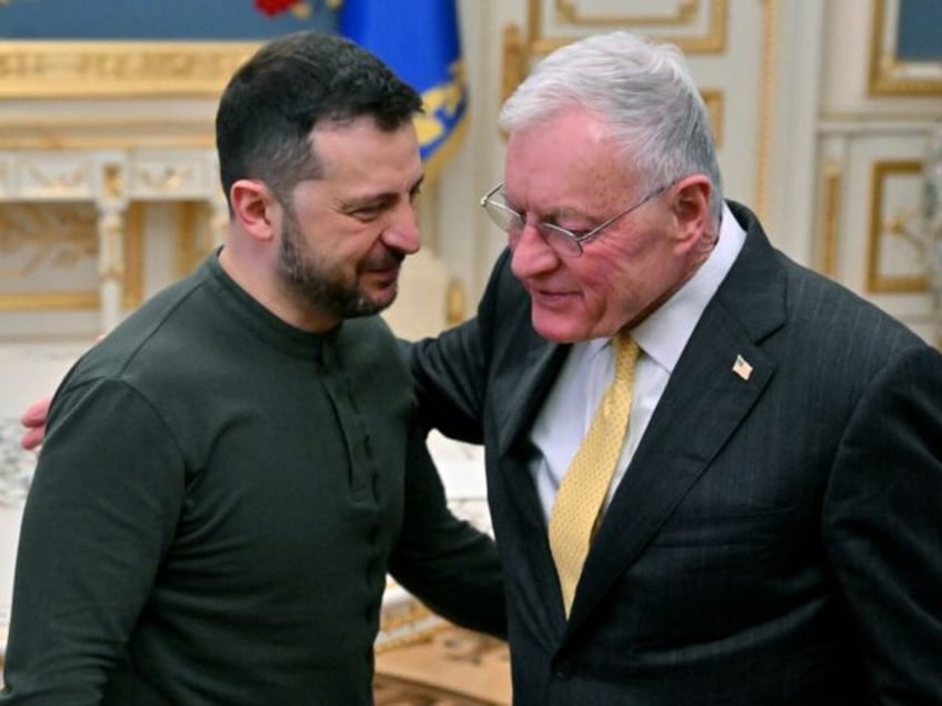 TOPSHOT - Ukraine's President Volodymyr Zelensky (L) greets US envoy Keith Kellogg at